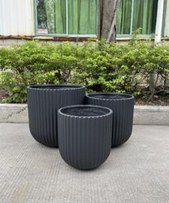 Lightweight and durable Fluted Garden Pots for indoor/outdoor use, crafted from glass-reinforced concrete. Perfect for a variety of plants, these pots add elegance to patios, balconies, and garden pathways.