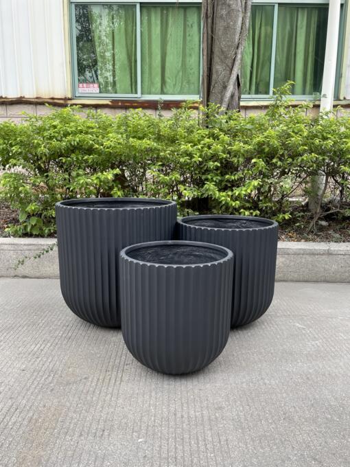 Lightweight and durable Fluted Garden Pots for indoor/outdoor use, crafted from glass-reinforced concrete. Perfect for a variety of plants, these pots add elegance to patios, balconies, and garden pathways.